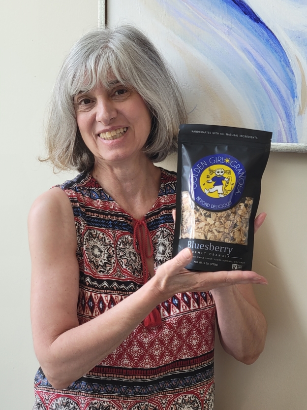 Owner Deborah O'Kelly showing Bluesberry granola bag